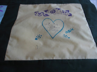 Pale Yellow background with fabric painted heart, flowers and message.