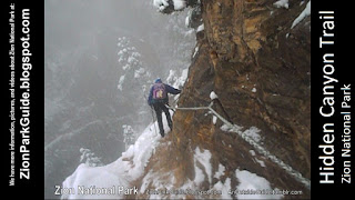 Zion National Park - Snow Hike - Hidden Canyon Trail - Hiking along cliff holding chains