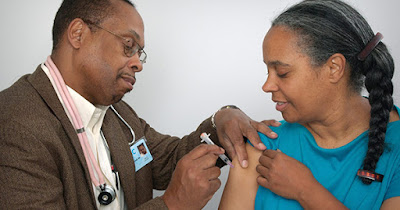 African American woman getting flu shot