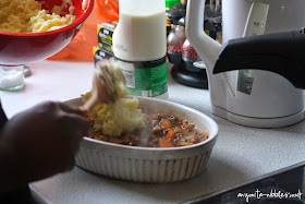 Adding mashed potatoes to cottage pie from anyonita-nibbles.co.uk