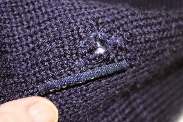 Mending a woollen jumper