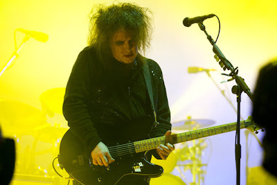 robert smith con su guitarra schecter ultracure con luces amarillas