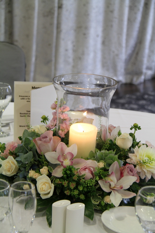 Tall Baroque style silver candelabras dressed with English Garden Roses 