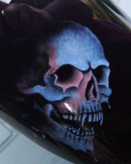 Detail of the main freehand airbrush artwork showing the blue metallic paint