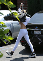  Miley Cyrus overs her face with a bag