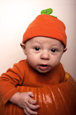 celebrating Halloween with a baby - taking pictures in a pumpkin