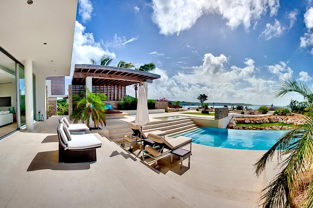 Outdoor furniture by the swimming pool and incredible ocean view