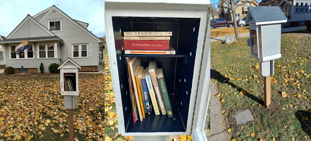 3 pics: Left is a view of the new street library in front of the house whose design it mirrors. The middle pic is a closeup of the first set of books being offered: a mix of fiction, mysteries, non-fiction, sports, a children's book, & two magazines.
