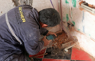 Bekir getting stuck in with the plumbing in Room 13