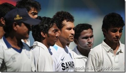 Indian cricketer Sachin Tendulkar (C) poses with ball boys after a team practice session at the Wankhede stadium in Mumbai on November 21, 2011. India are looking to keep the pressure on the beleaguered West Indies in the third and final Test of their series starting in Mumbai on November 22 as they seek to seal a 3-0 series whitewash. Tendulkar, the world's leading scorer in both Test and one-day cricket, needs just one more hundred to complete an unprecedented century of centuries, having already made 51 in Tests and 48 in one-day internationals. AFP PHOTO/Punit PARANJPE (Photo credit should read PUNIT PARANJPE/AFP/Getty Images)