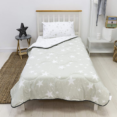 Bed with coverless grey and white star duvet on top