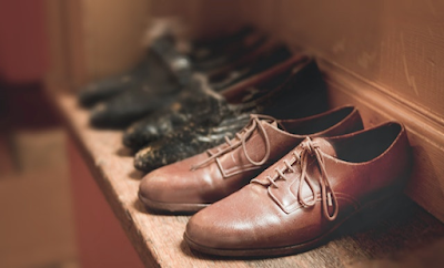 Pair of Brown Leather Shoes Lying on Shelf