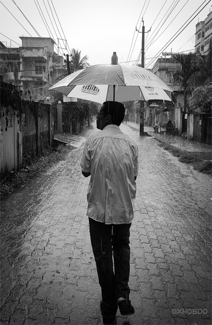 Man in rain with umbrella