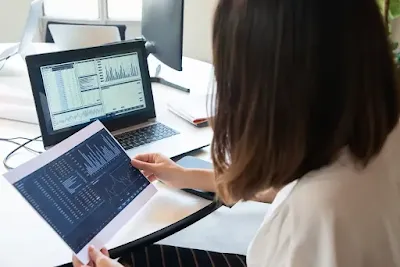 Small business CRM features displayed on computer screen with sales analytics charts and customer management tools