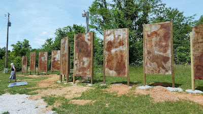 Carlos' latest art installation in progress at IONA: Art Sanctuary. Sally is walking to its left. 