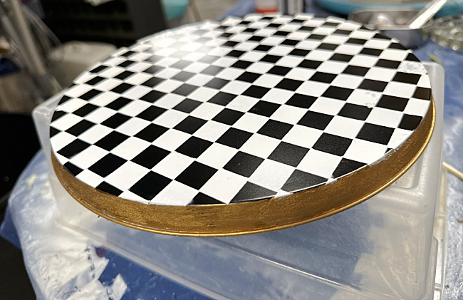 black and white checked pattern with gold rim