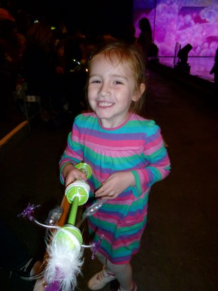 sasha with light up toy and big grin