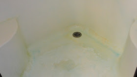 Corner shower soap scum sprayed with blue Dawn solution