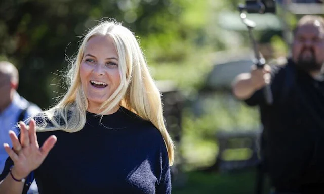 Crown Princess Mette-Marit wore a navy blue cashmere sweater. Fjallraven black and beige trekking trousers