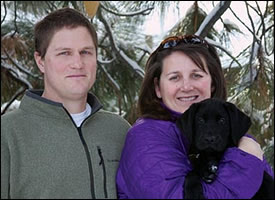 GDB puppy raiser Megan Minkiewicz and husband Alex with black Lab puppy-in-training Caleb