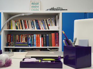 Reference book spines, including Roget's Thesaurus and the Oxford Concise Thesaurus, on Plum Copy's book shelf