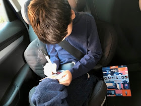 Child with Games on the Go in the car