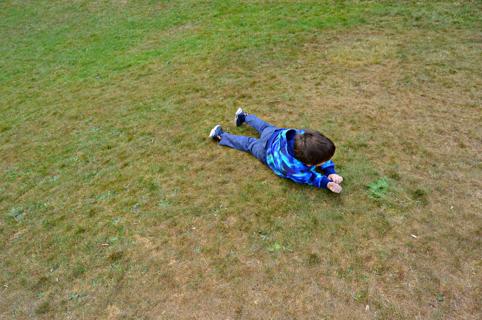 boy rolling down a hill