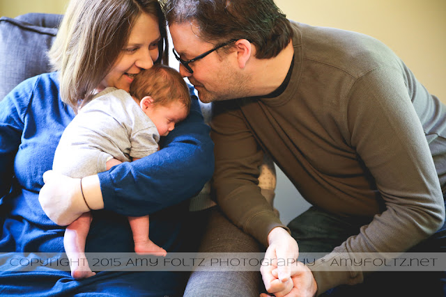 lifestyle photo of newborn and parents