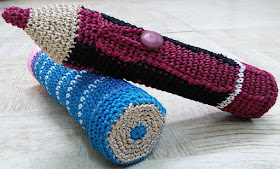 photo of two crochet pencil boxes - one shaped like a pencil with a point and one a 'new unsharpened pencil'
