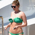 Water BABE Holly Candy flaunts figure curves bright emerald bikini lounges yacht sea Sardinia husband Nick baby Luka