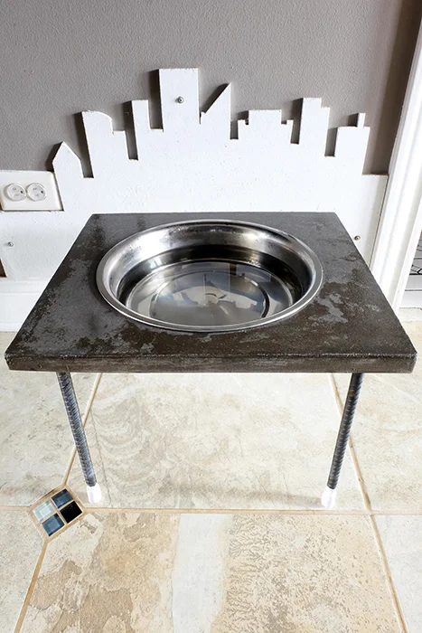 water bowl stand for a dog made of concrete and rebar