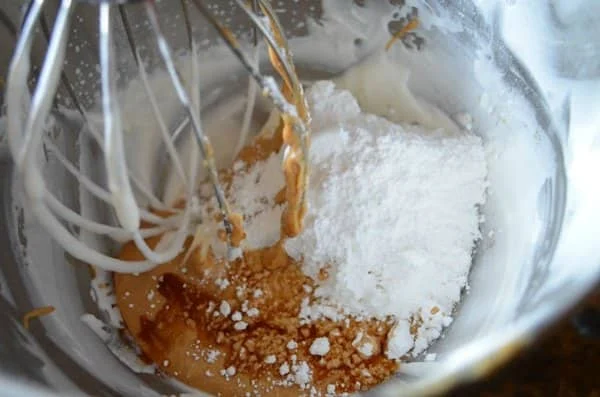 Mixing bowl with peanut butter mixture with powdered sugar and vanilla for No Bake Peanut Butter Fudge Pie.