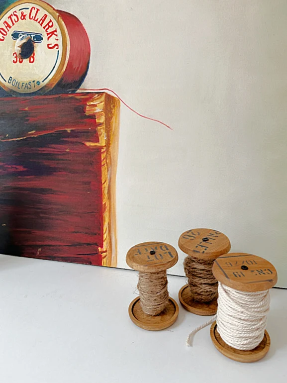 wooden spools with oil painting of thread spool