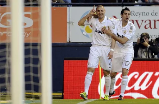 Karim Benzema celebrates with Real Madrid team-mate Álvaro Arbeloa after scoring against Osasuna