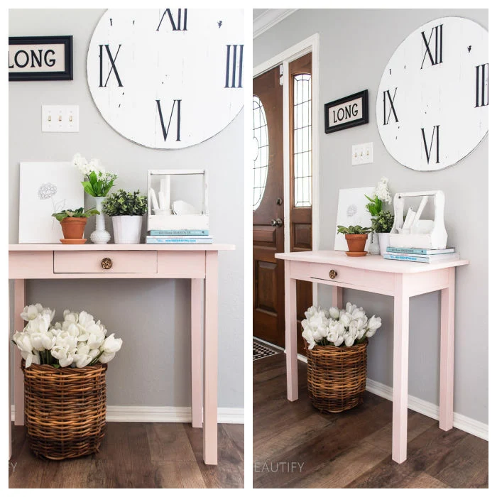 vintage pink entryway table with flowers and books