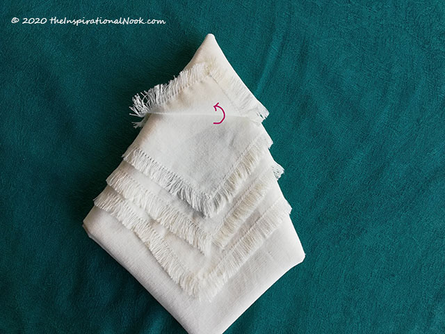 Step by step tutorial to fold a napkin into a Christmas tree