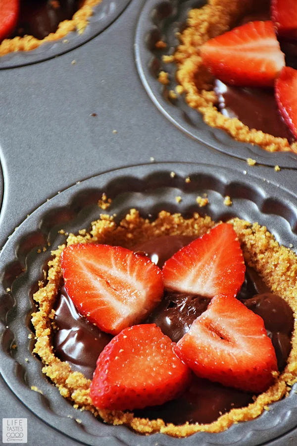 Fresh Florida strawberries sliced and arranged on top of chocolate ganache