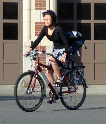 girl in a skirt riding her bike in Boston