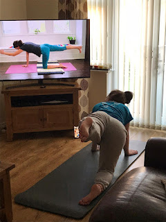 Girl doing yoga with Adrienne