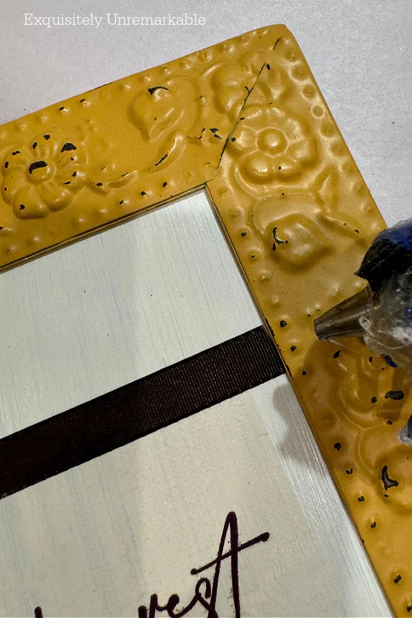 Hot Glue Ribbon onto the sign around the napkin edges