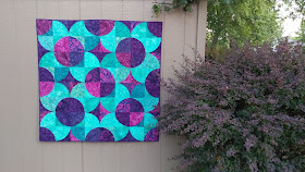 Fizzy block modern quilt using purple and teal Island Batik fabrics