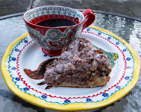 A slice of Duck Egg and Brown Butter Coffee Cake with a cup of Jay D's Single Origin Coffee