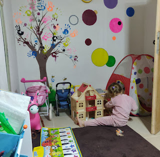 Rosie playing with her dolls house before school