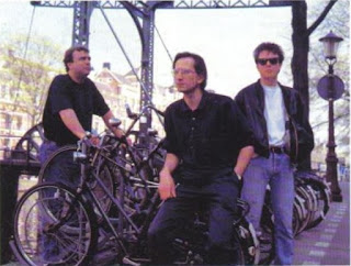 The Bitmap Brothers in front of some bikes and a bridge, in Amsterdam