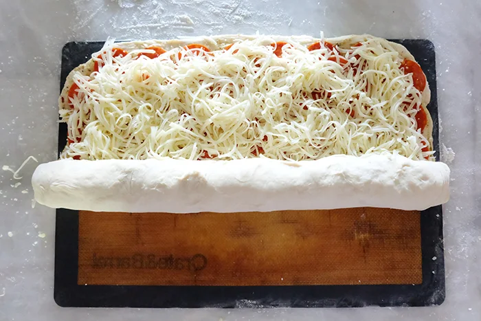 rolling pepperoni bread dough into a log