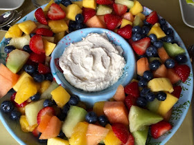 Fresh fruit salad with mango, melon, strawberries and blueberries