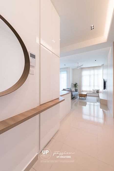 The vyne condo entrance foyer with wood top cabinet as a divider from kitchen with rounded wood frame mirror and small ledge for decor and small stuffs