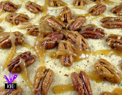 extra maple covered pecans on top of a creamy and delicious cheesecake