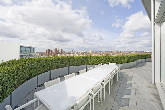 Picture of white large dining table on the terrace overlooking the city