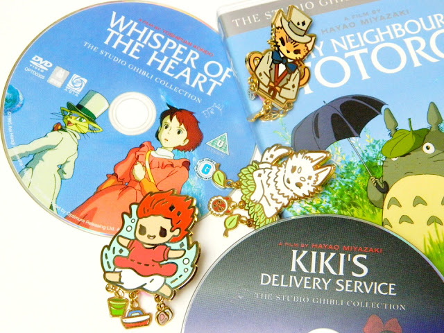 A photo showing a collection of Studio Ghibli DVDs and enamel pins by PokoPins